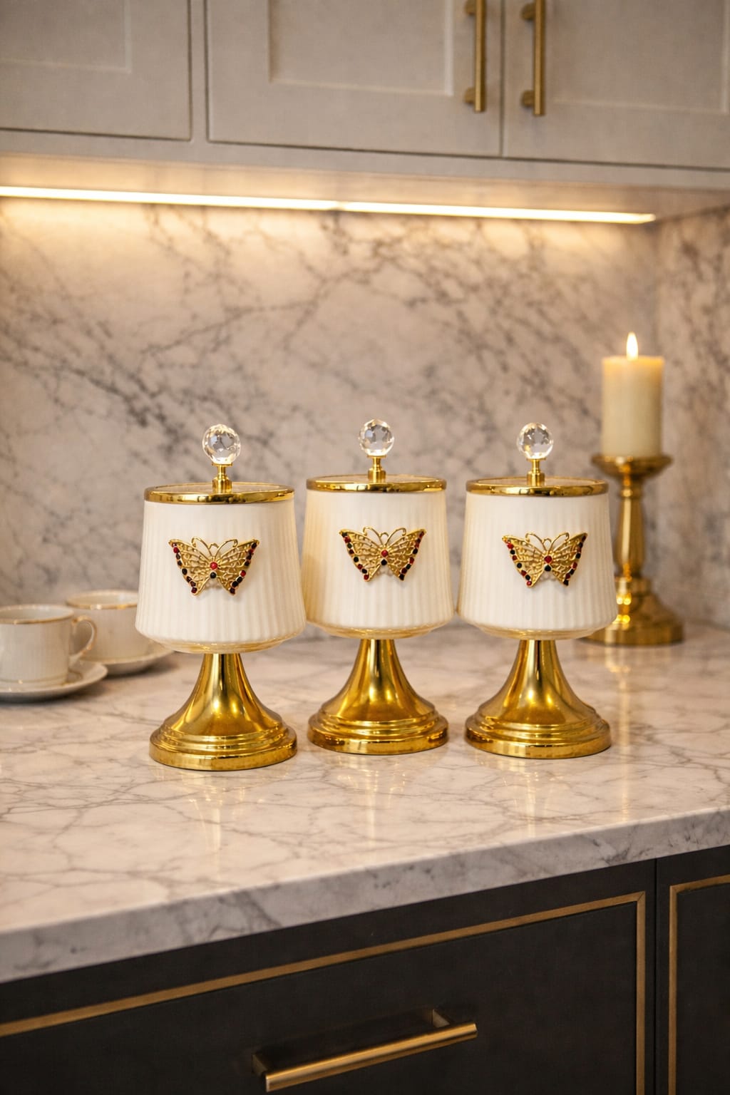 White spice jars with elegant gold bases and butterfly details