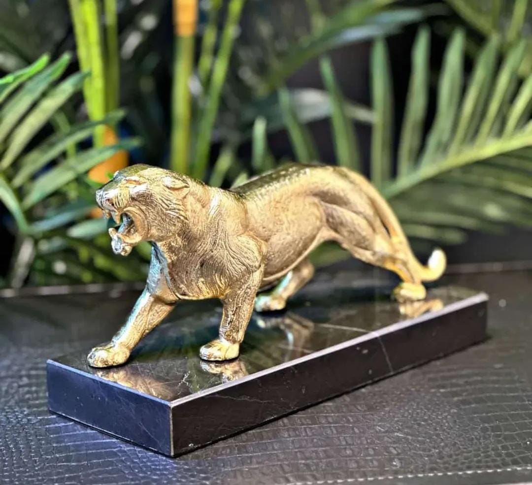 Gold lion statue on black marble