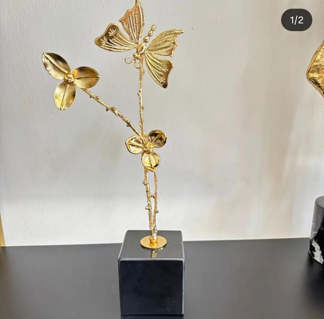 2 flowers and butterfly on black marble